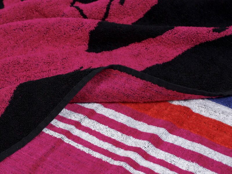 Large beach towel with pink polo by Stofex.