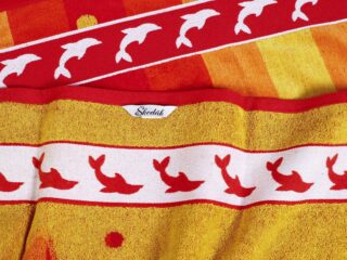 Large beach towel with orange dolphin by Stofex.