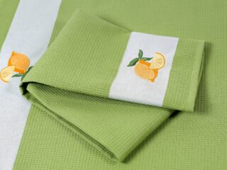 Waffle kitchen towel with lemon on green background from 100% cotton.