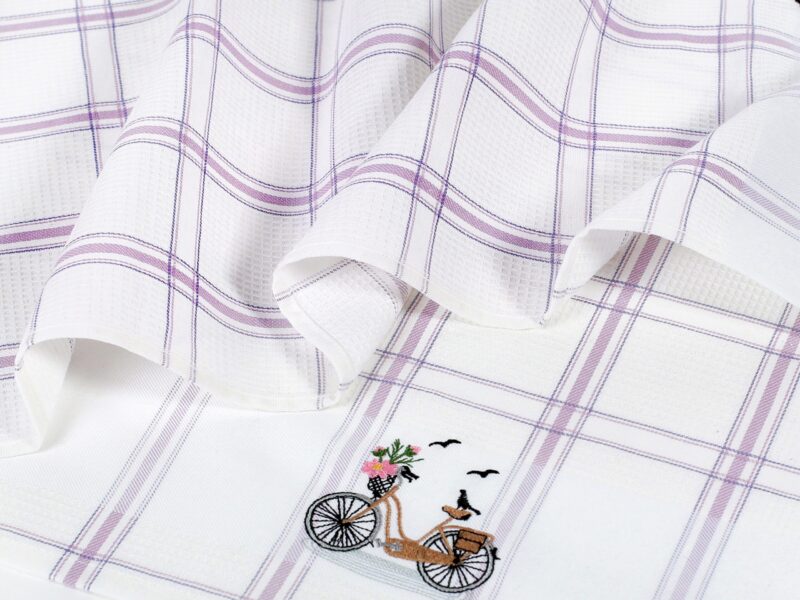 Waffle kitchen towel with bike and purple stripes from 100% cotton.