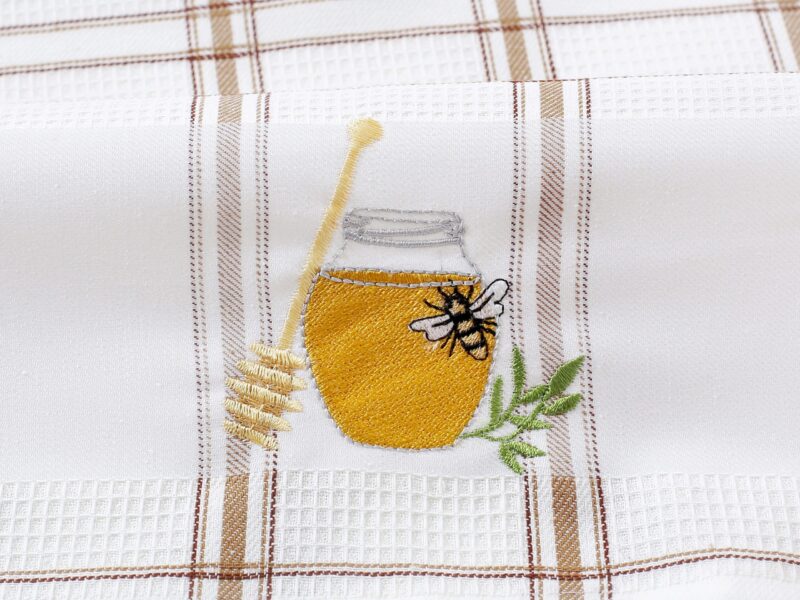 Waffle kitchen towel with honey jar and brown stripes from 100% cotton.