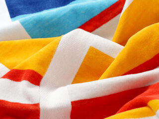 Large beach towel with colourful stripes by Stofex.